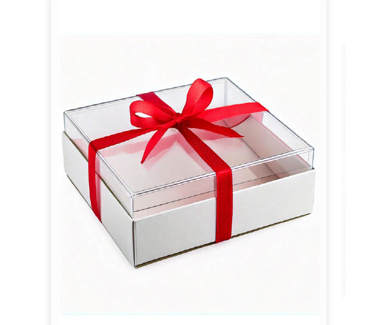 A clear plastic box with a white base, adorned with a red ribbon and a red bow on top.
