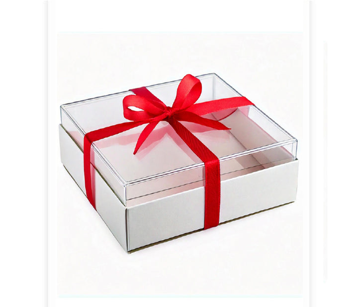A clear plastic box with a white base, adorned with a red ribbon and a red bow on top.